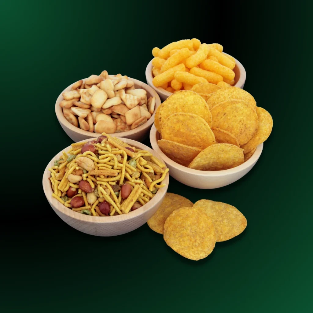 Assorted bakery snacks, namkeen, and biscuits in bowls for tea time delivery.