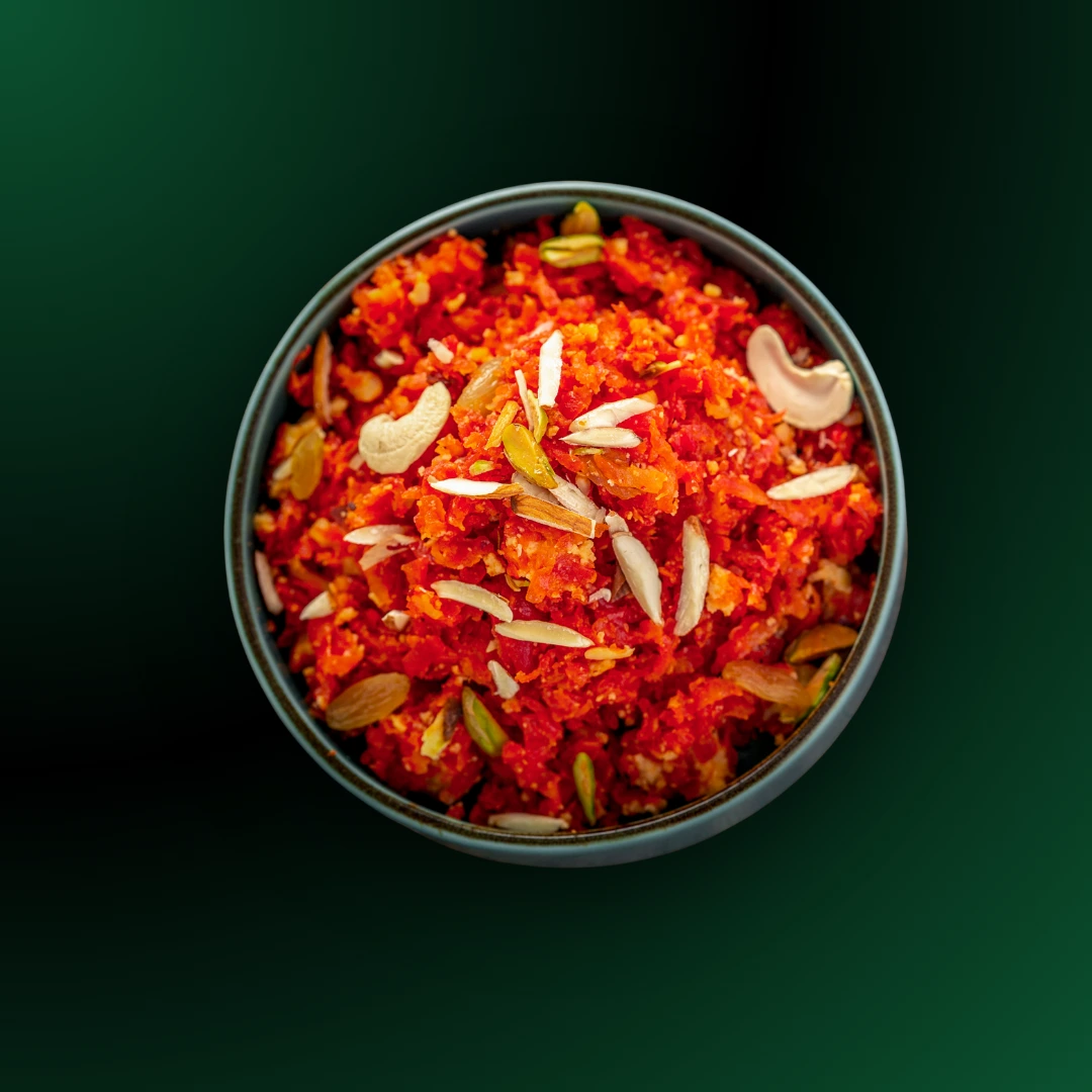 Delicious Gajar Ka Halwa garnished with dry fruits available for online delivery in Seohara Express app.