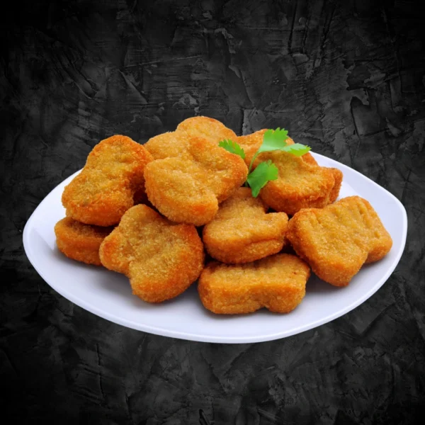 Chicken Nuggets 6 Pcs Plate Golden fried chicken nuggets piled on a white plate with coriander garnish on dark background - Seohara Kitchen