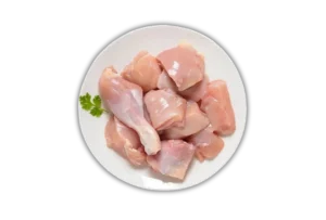 Fresh Raw Chicken Curry Cut - 1kg Pack Plate of fresh, pink, raw chicken curry cut pieces with skinless drumsticks and breast pieces. Order fresh halal chicken online from Seohara Express in Seohara, Bijnor.