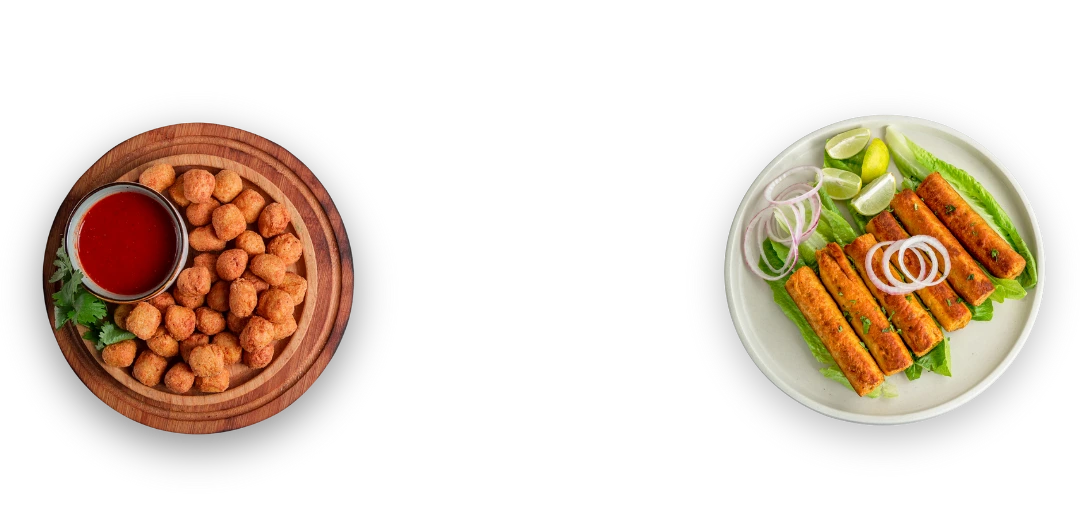 Plates of fried chicken popcorn and chicken seekh kebabs on a green background. Category thumbnail for frozen non-veg snacks delivery by Seohara Express.