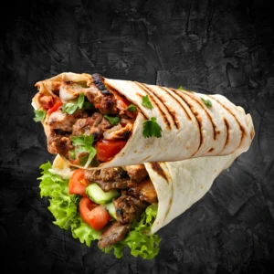 Chicken seekh kebab roll with green chutney and onion salad on a dark background - Seohara Kitchen